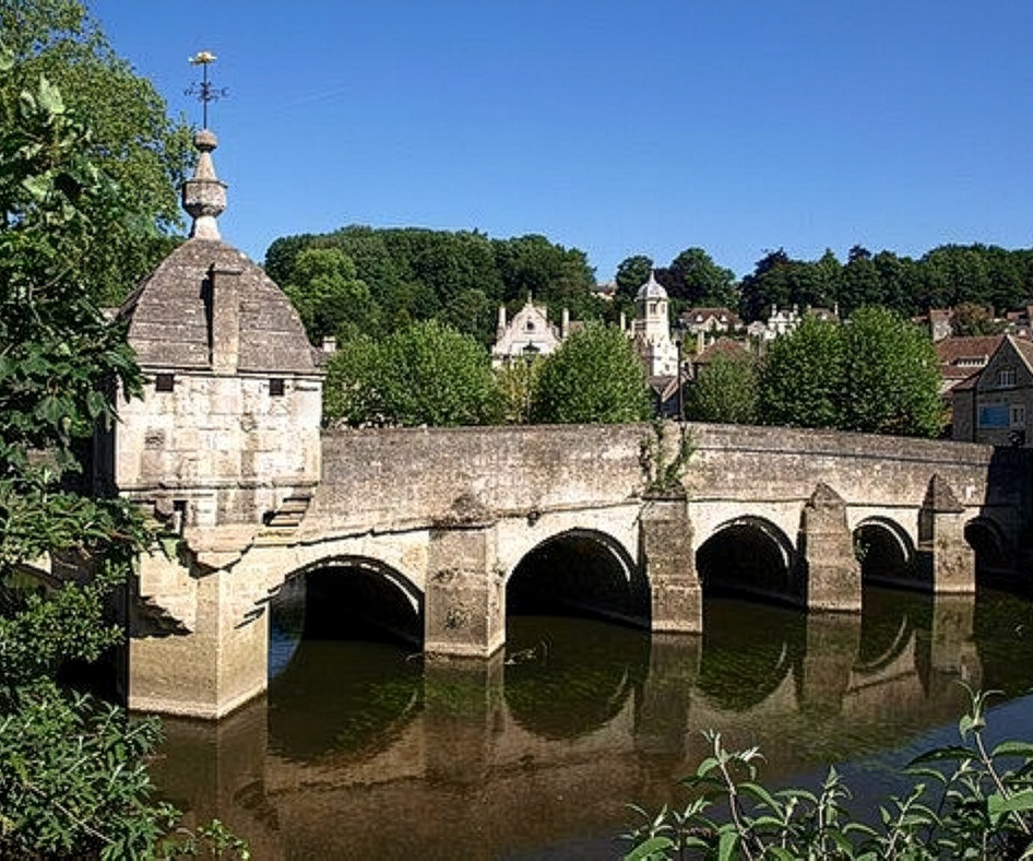 Bradford on Avon Town Bridge. A 13th-century stone bridge in the town center, featuring nine arches and a unique 18th-century "lock-up" jail building with a fish-shaped weather vane known as the Bradford Gudgeon.